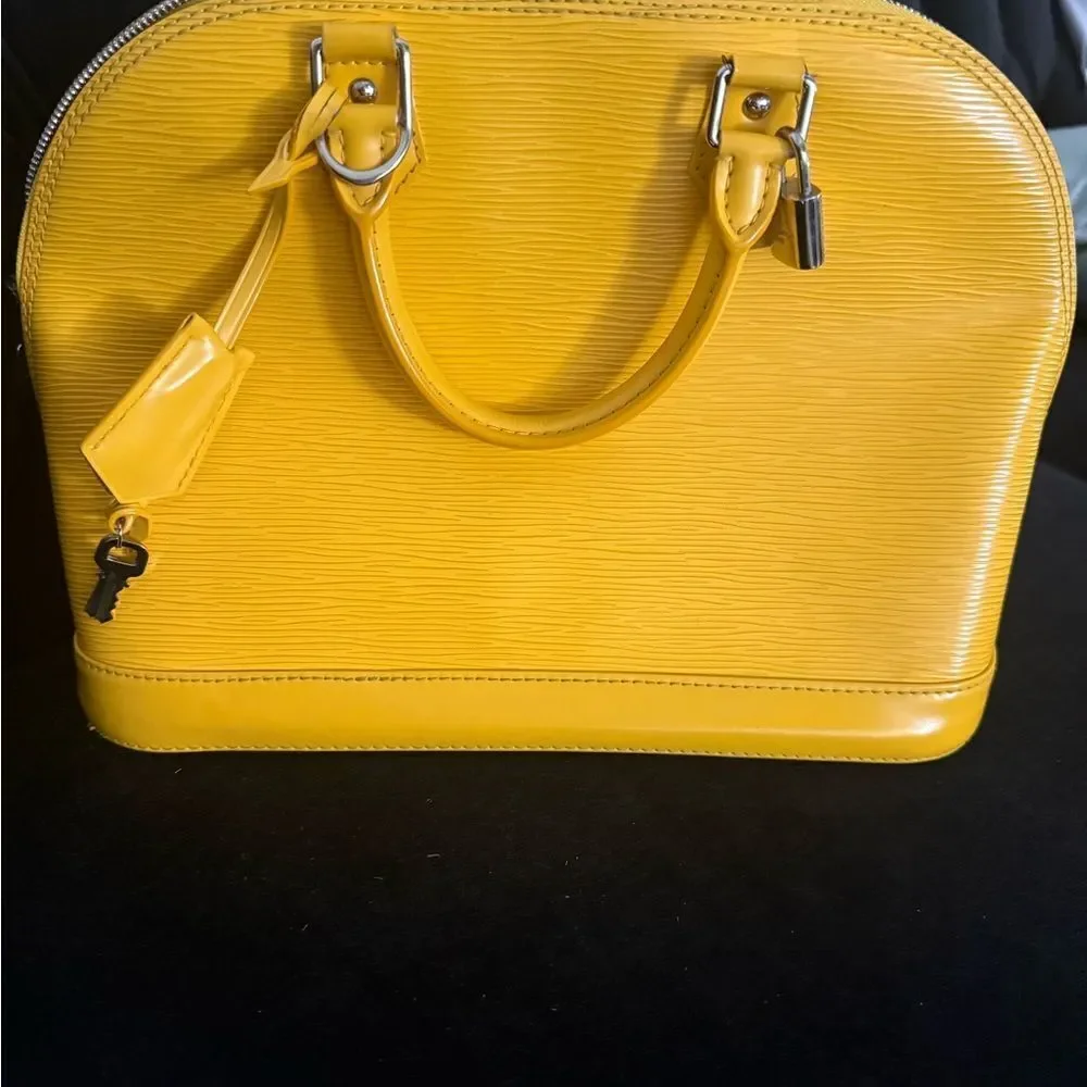 Used excellent condition Louis Vuitton Epi Alma BB with strap